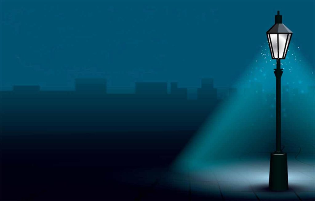 Un lampadaire dans une rue sombre.